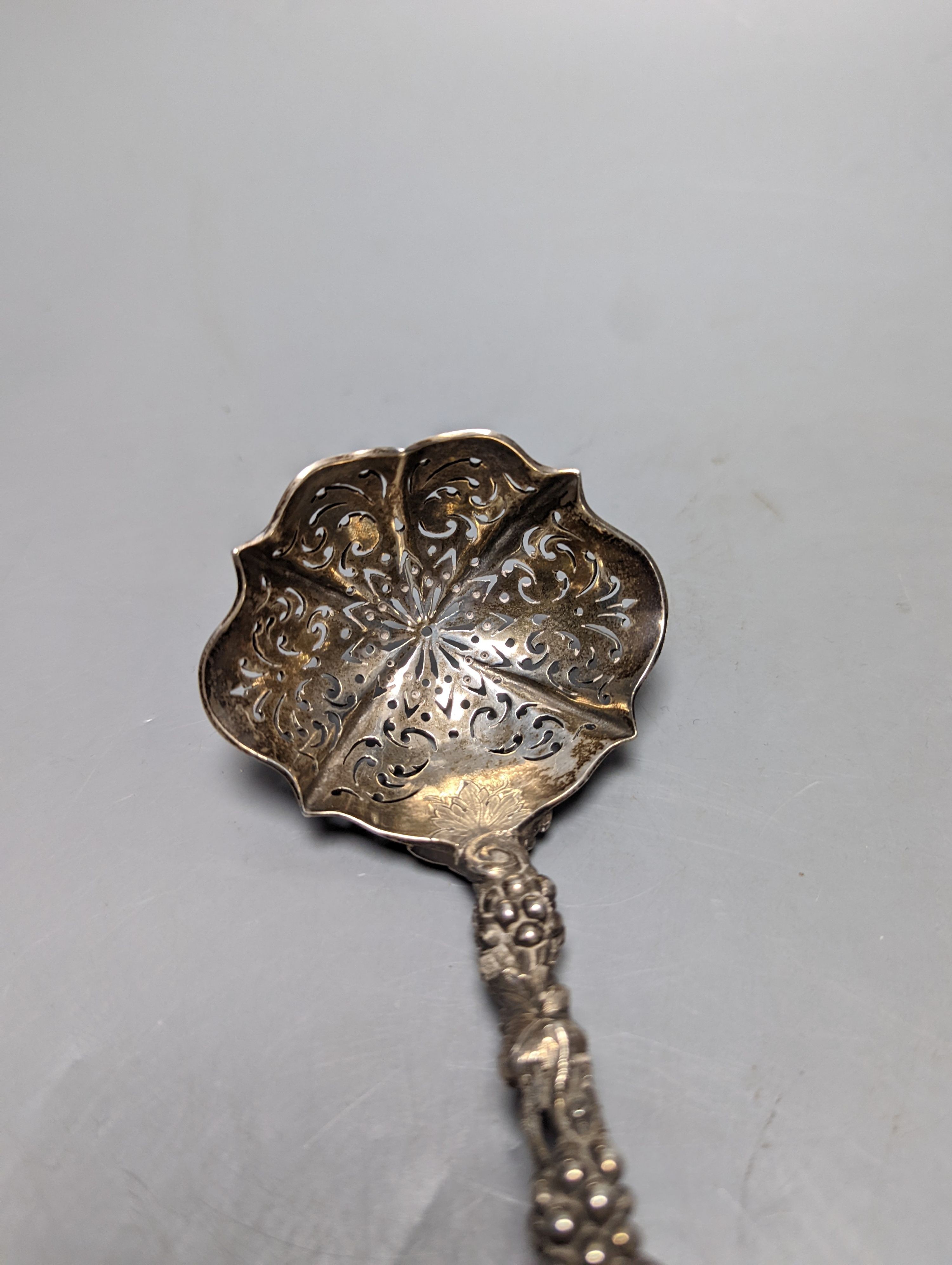 A late 19ty century Russian 84 zolotnik sifter ladle, assay master Ludvig Zug, 187?, 18.7cm, and a Victorian silver sifter spoon with vineous handle, 5oz.
